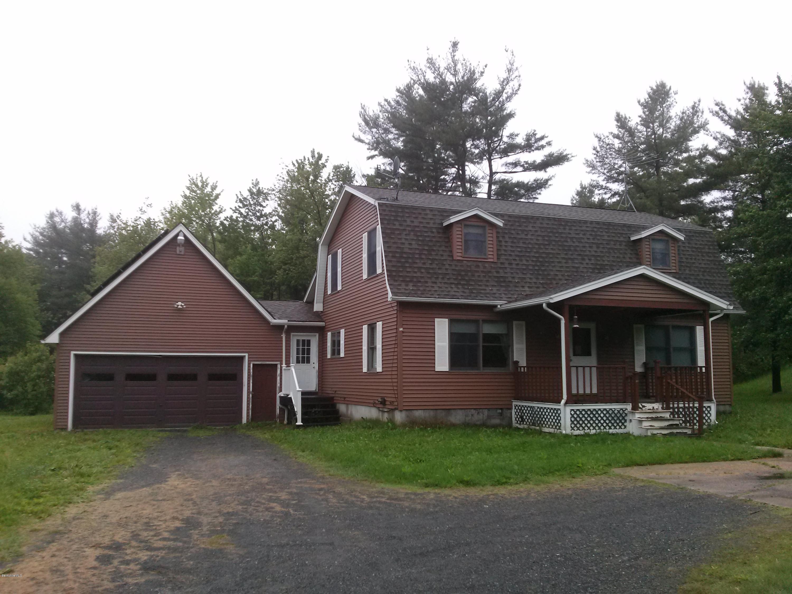 102 East Main Road Peru, MA 01235 - Photo 1 of 21 a front view of a house with a garden and trees