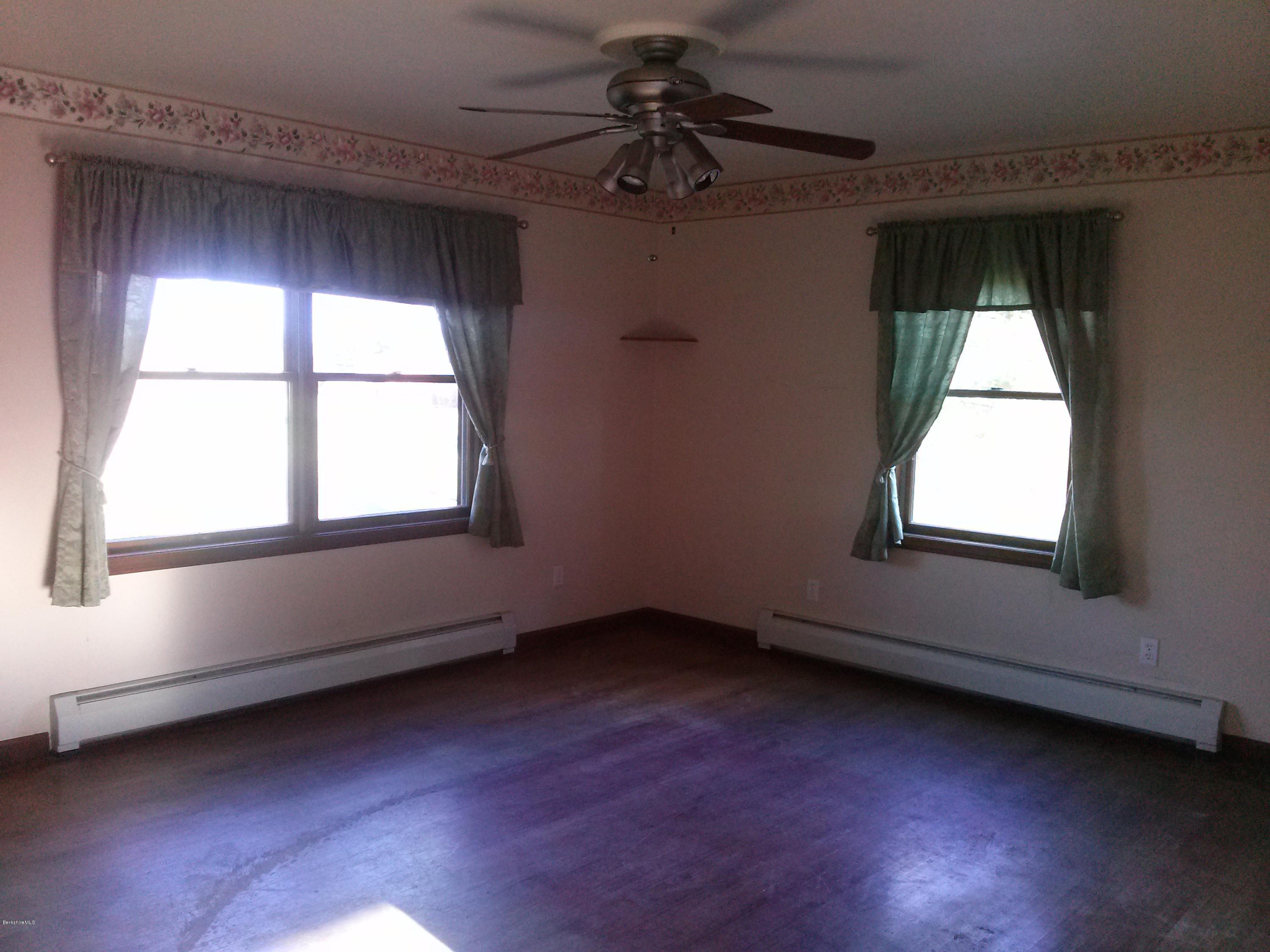 102 East Main Road Peru, MA 01235 - Photo 5 of 21 an empty room with wooden floor and windows