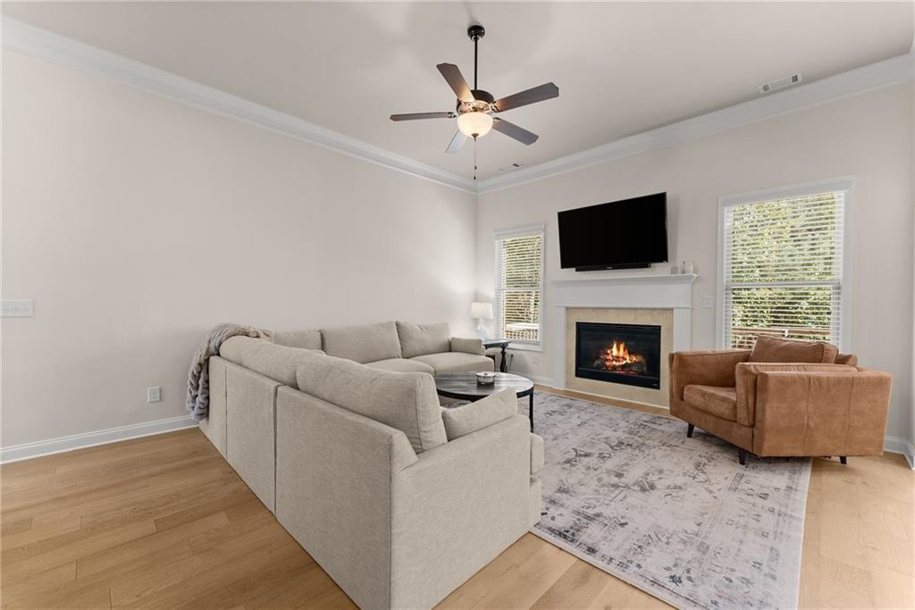 8055 Veranda Curve Ball Ground, GA 30107 - Photo 16 of 65 a living room with furniture a flat screen tv and a fireplace
