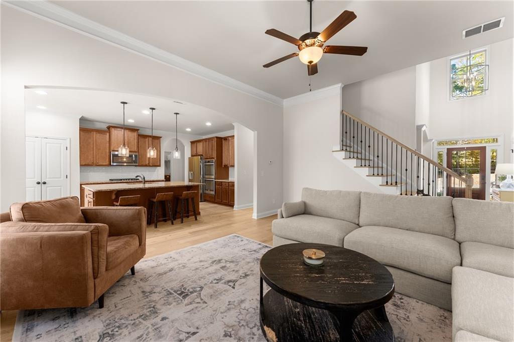 8055 Veranda Curve Ball Ground, GA 30107 - Photo 17 of 65 a living room with furniture and a chandelier
