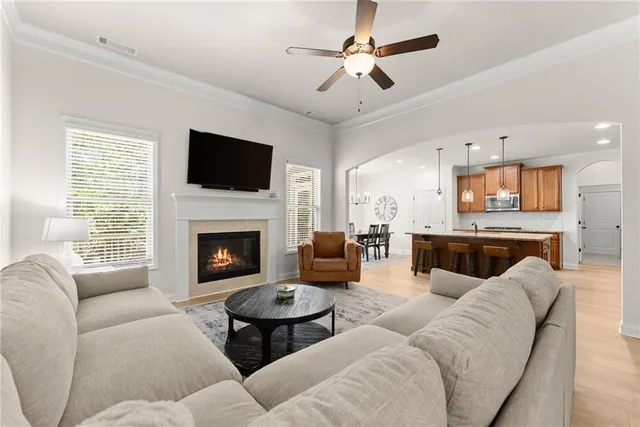 a kitchen with kitchen island granite countertop a table chairs sink and refrigerator