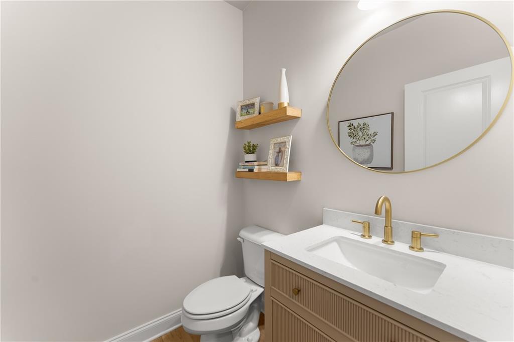 8055 Veranda Curve Ball Ground, GA 30107 - Photo 29 of 65 a bathroom with a toilet a sink and mirror
