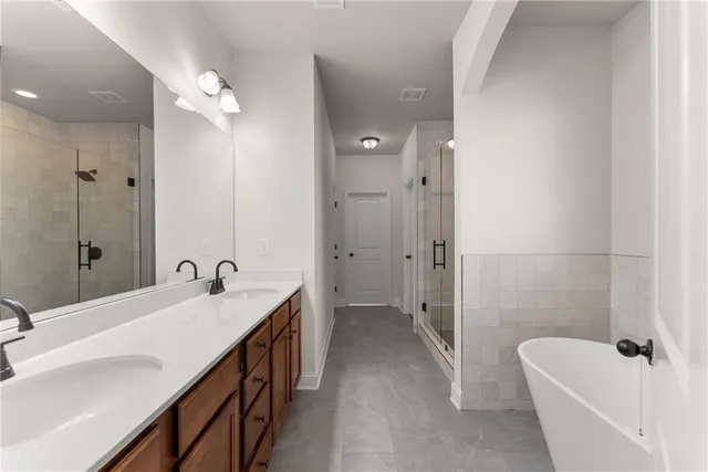a bathroom with a granite countertop sink a toilet a mirror and shower curtain