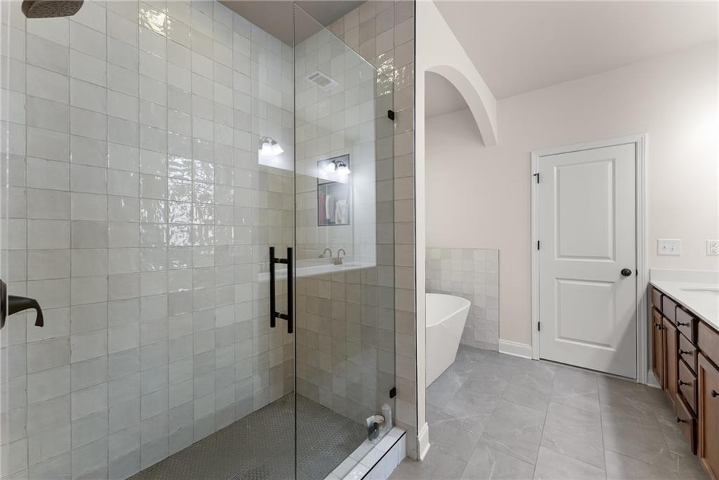 8055 Veranda Curve Ball Ground, GA 30107 - Photo 34 of 65 a bathroom with a shower