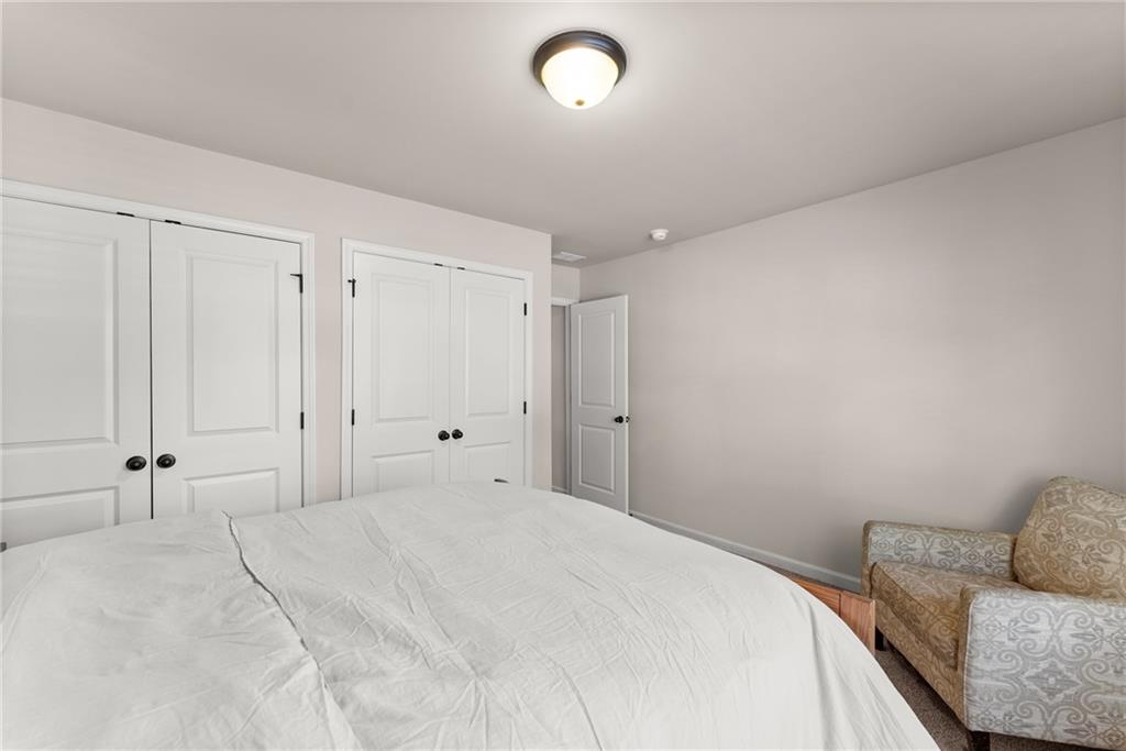 8055 Veranda Curve Ball Ground, GA 30107 - Photo 38 of 65 a bedroom with a bed and a couch