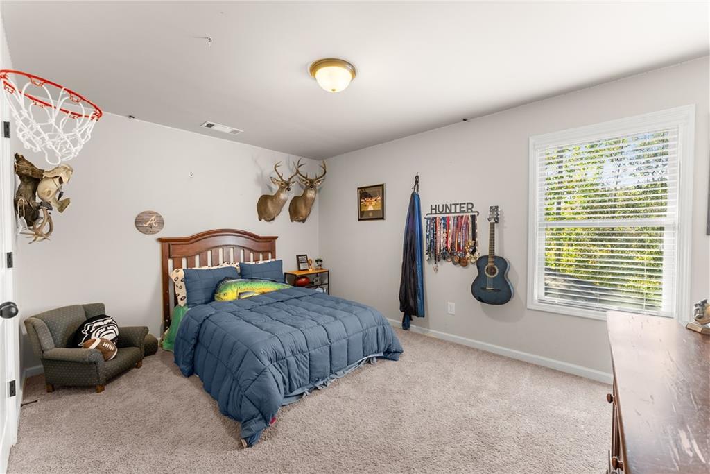 8055 Veranda Curve Ball Ground, GA 30107 - Photo 43 of 65 a bedroom with furniture and a window