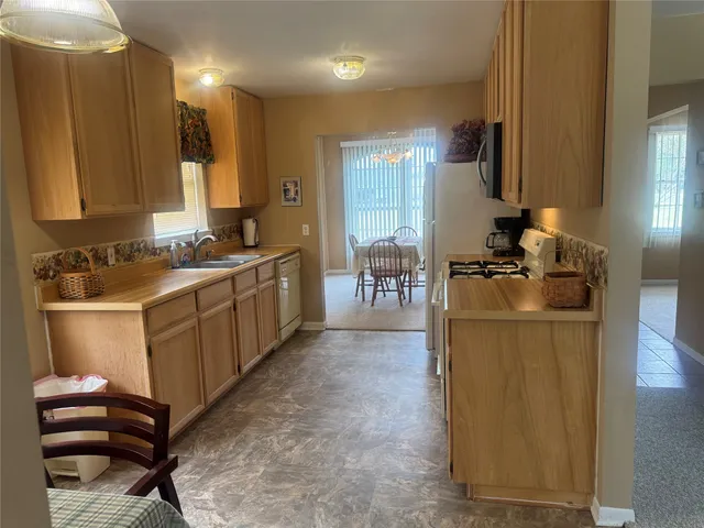 a kitchen with a sink appliances and cabinets