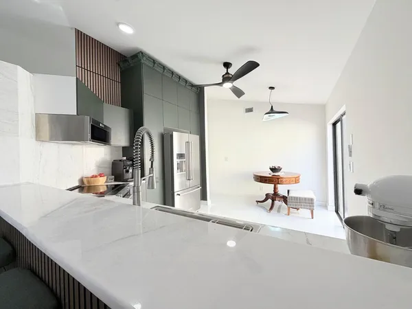a living room with furniture and a floor to ceiling window