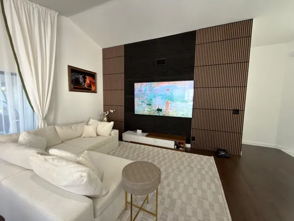 a view of a livingroom with furniture and a flat screen tv