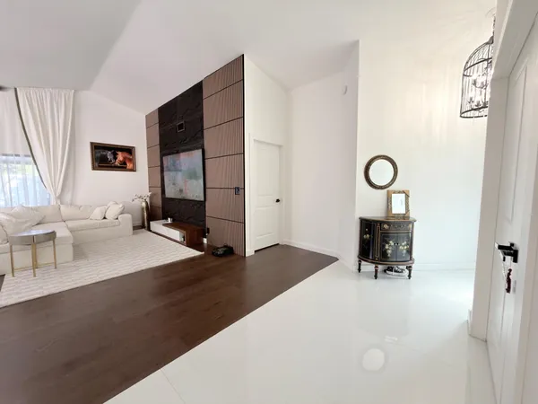 a living room with furniture and a floor to ceiling window