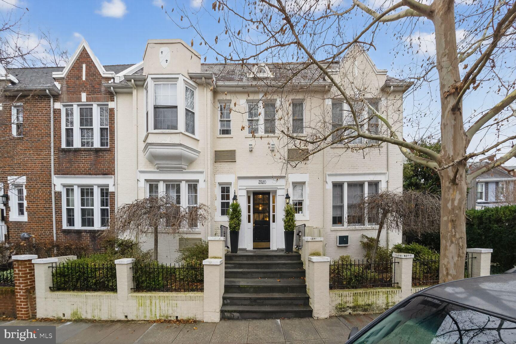 a front view of a residential apartment building with a yard