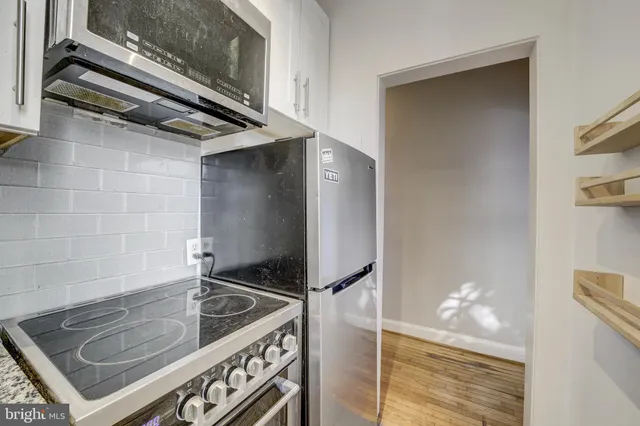 a kitchen with a stove and a microwave