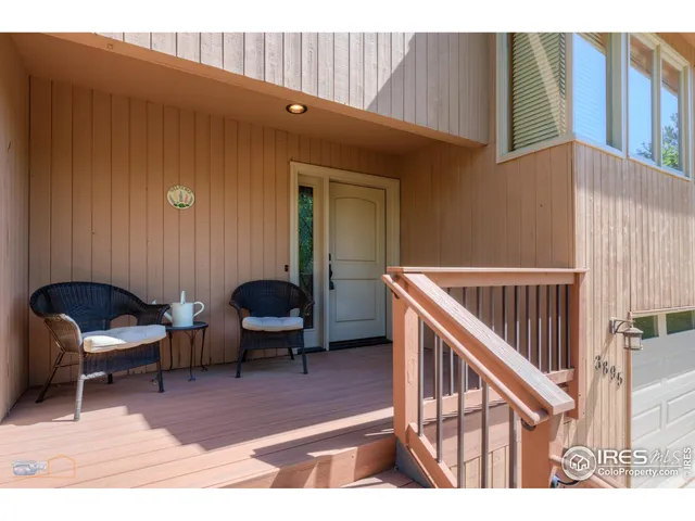 a balcony with chairs and a table