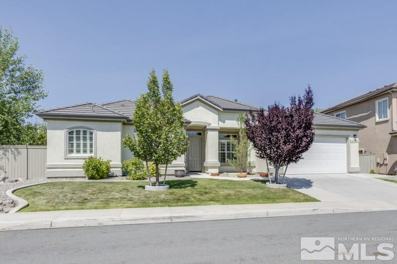 10555 Kenai Drive Reno, NV 89521 - Photo 1 of 1 a front view of a house with a yard and garage