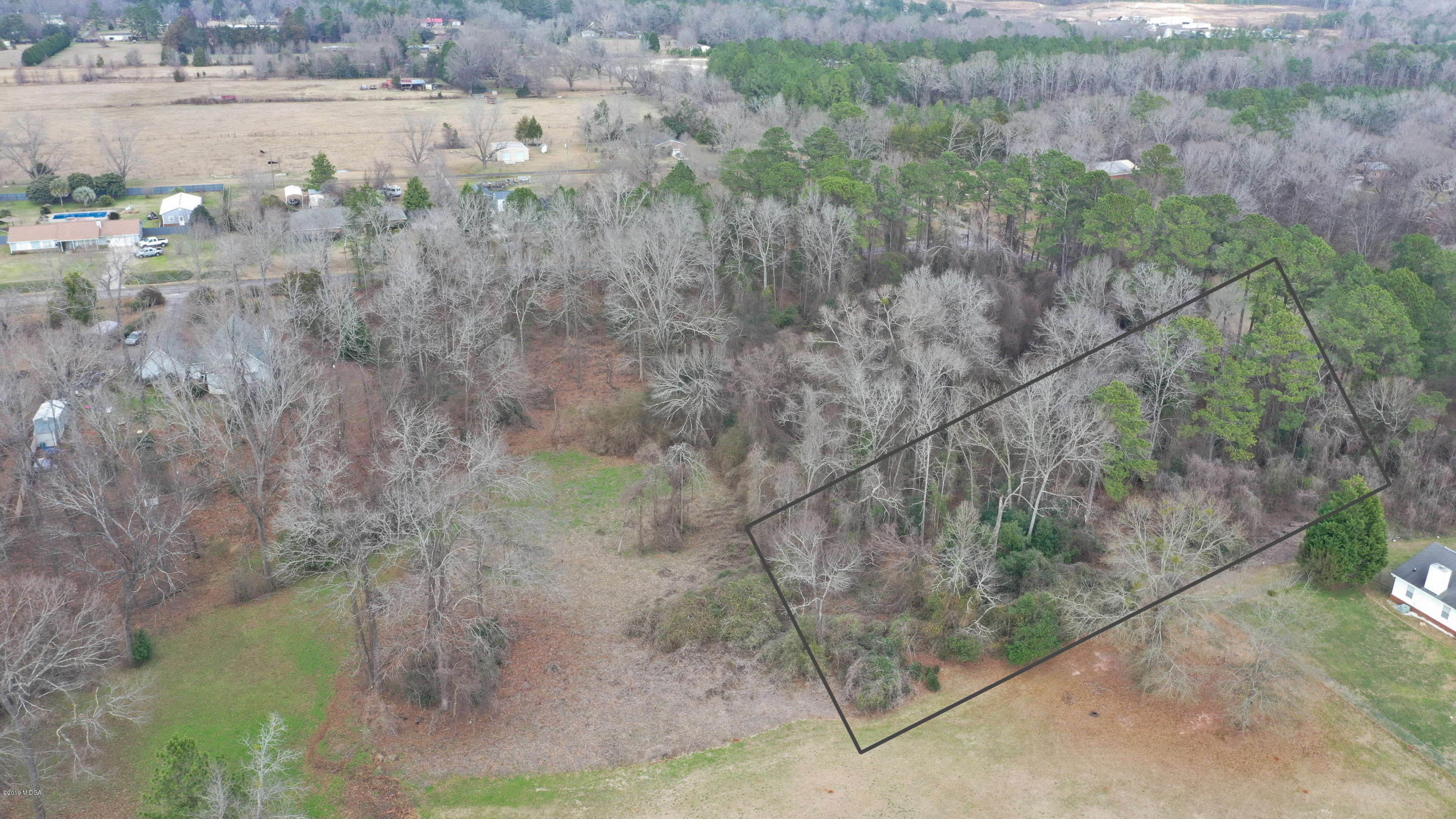 Lot 16 Housers Mill Road Fort Valley, GA 31030 - Photo 4 of 19 a view of a yard with trees in the background
