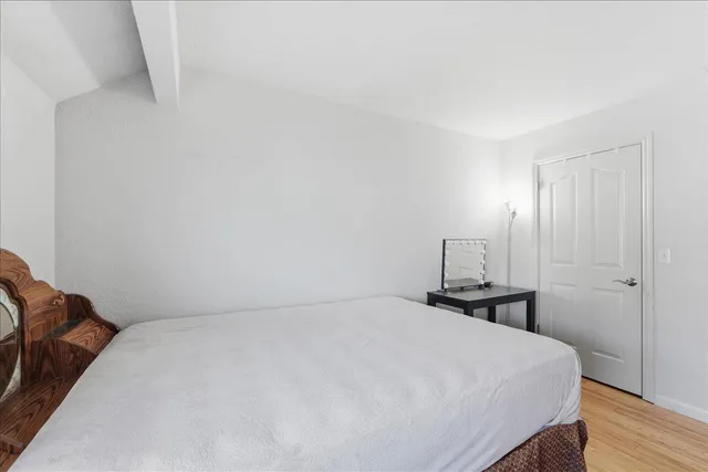 a bedroom with a bed and a night stand