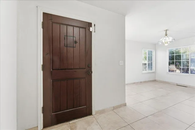 an empty room with windows and entrance