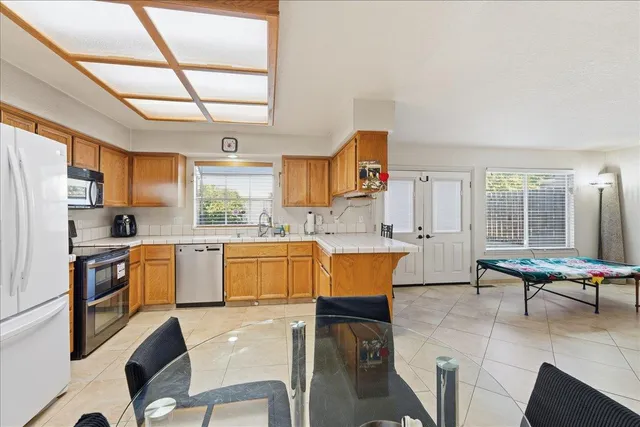 a kitchen with a table chairs sink and cabinets
