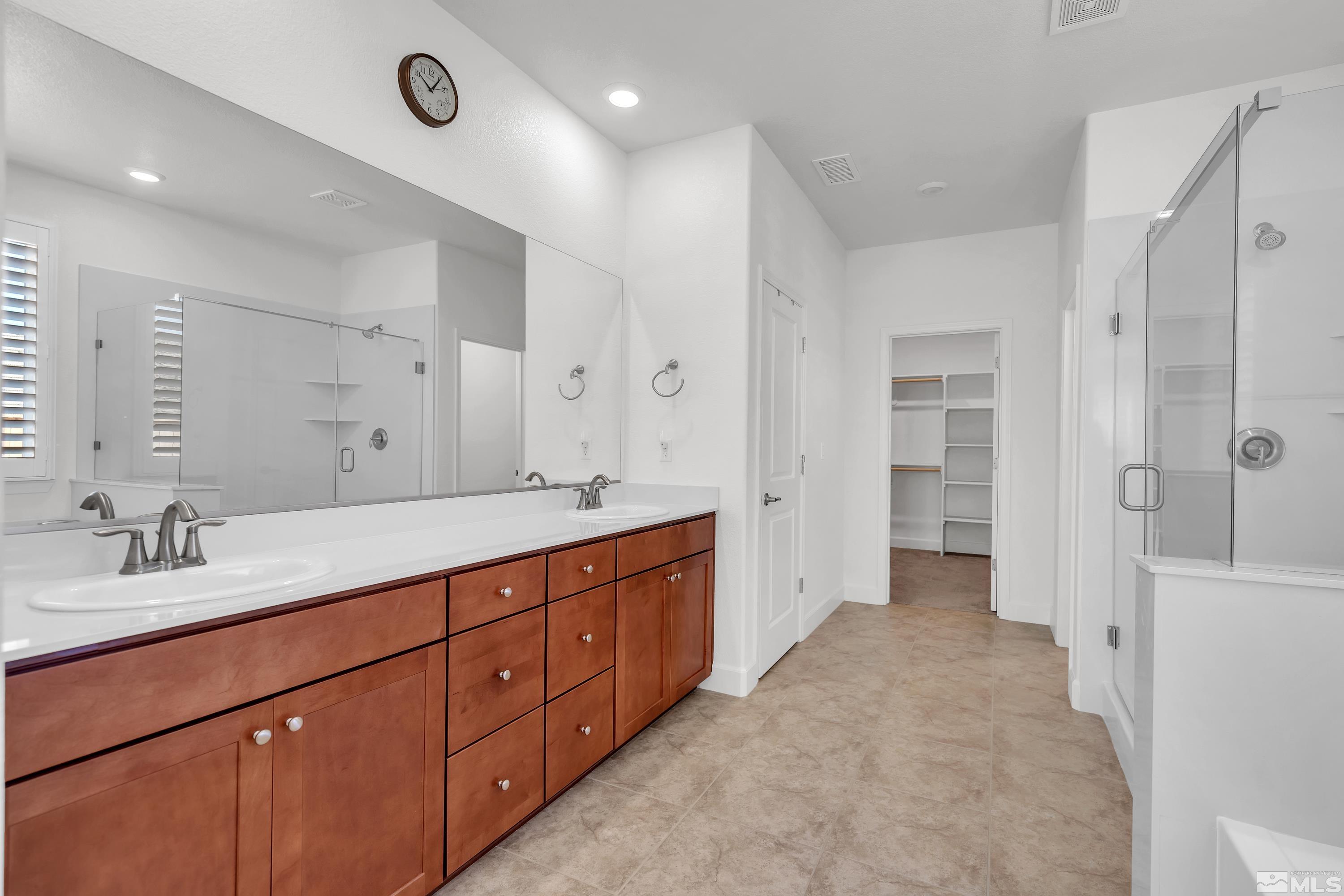 10310 Alchemy Way Reno, NV 89521 - Photo 14 of 30 a spacious bathroom with double vanity and mirrors