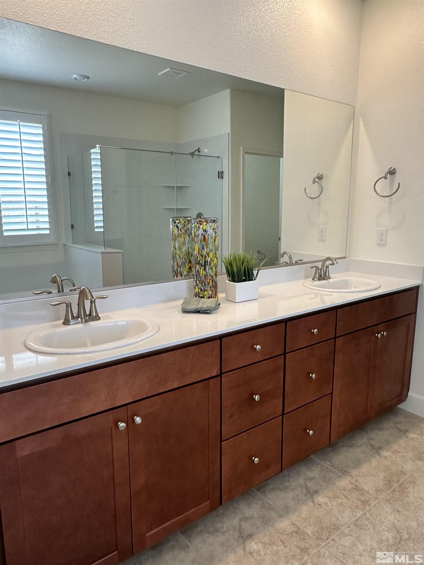 10310 Alchemy Way Reno, NV 89521 - Photo 15 of 30 a bathroom with double vanity sink and large mirror