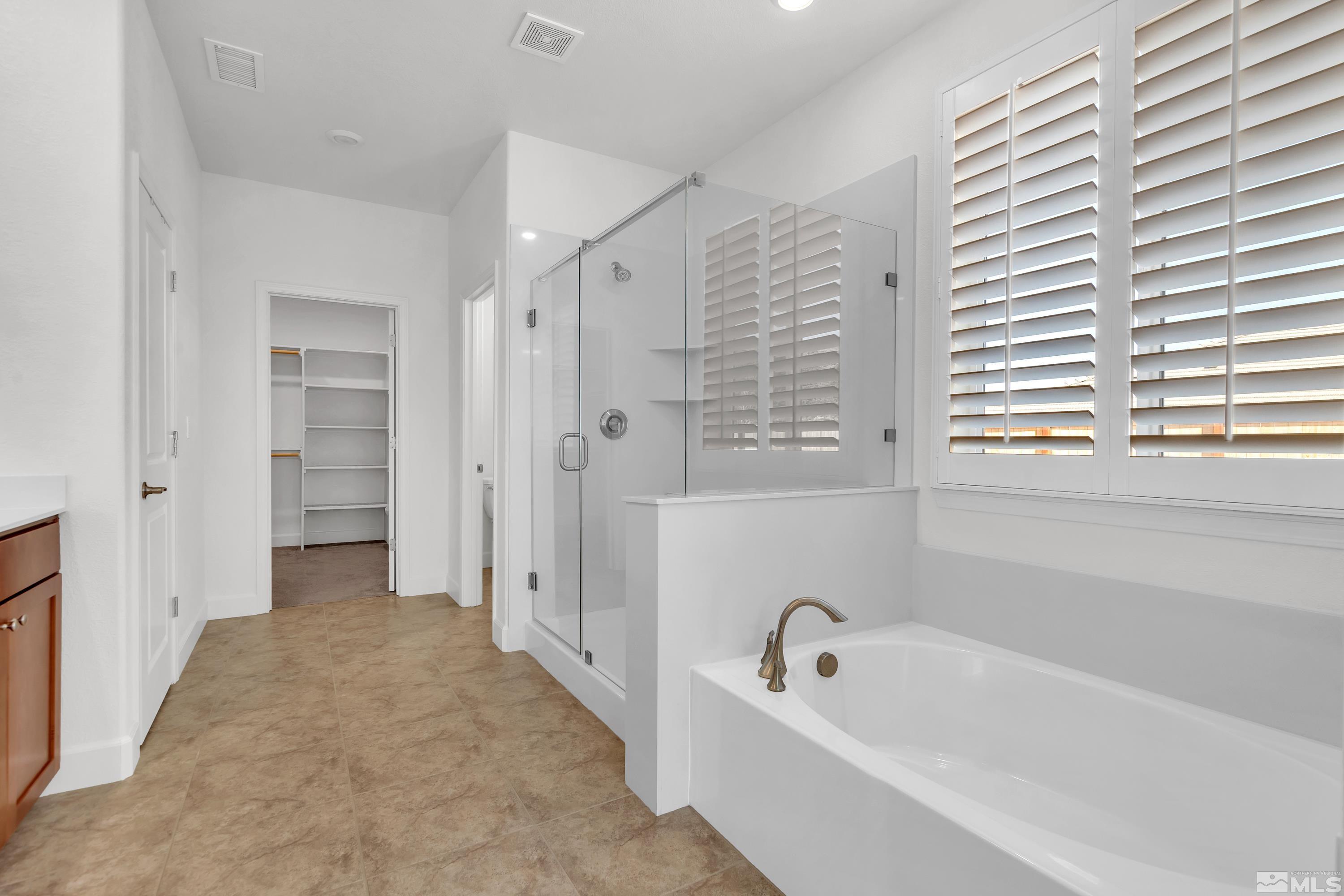 10310 Alchemy Way Reno, NV 89521 - Photo 16 of 30 a bathroom with a tub shower and sink