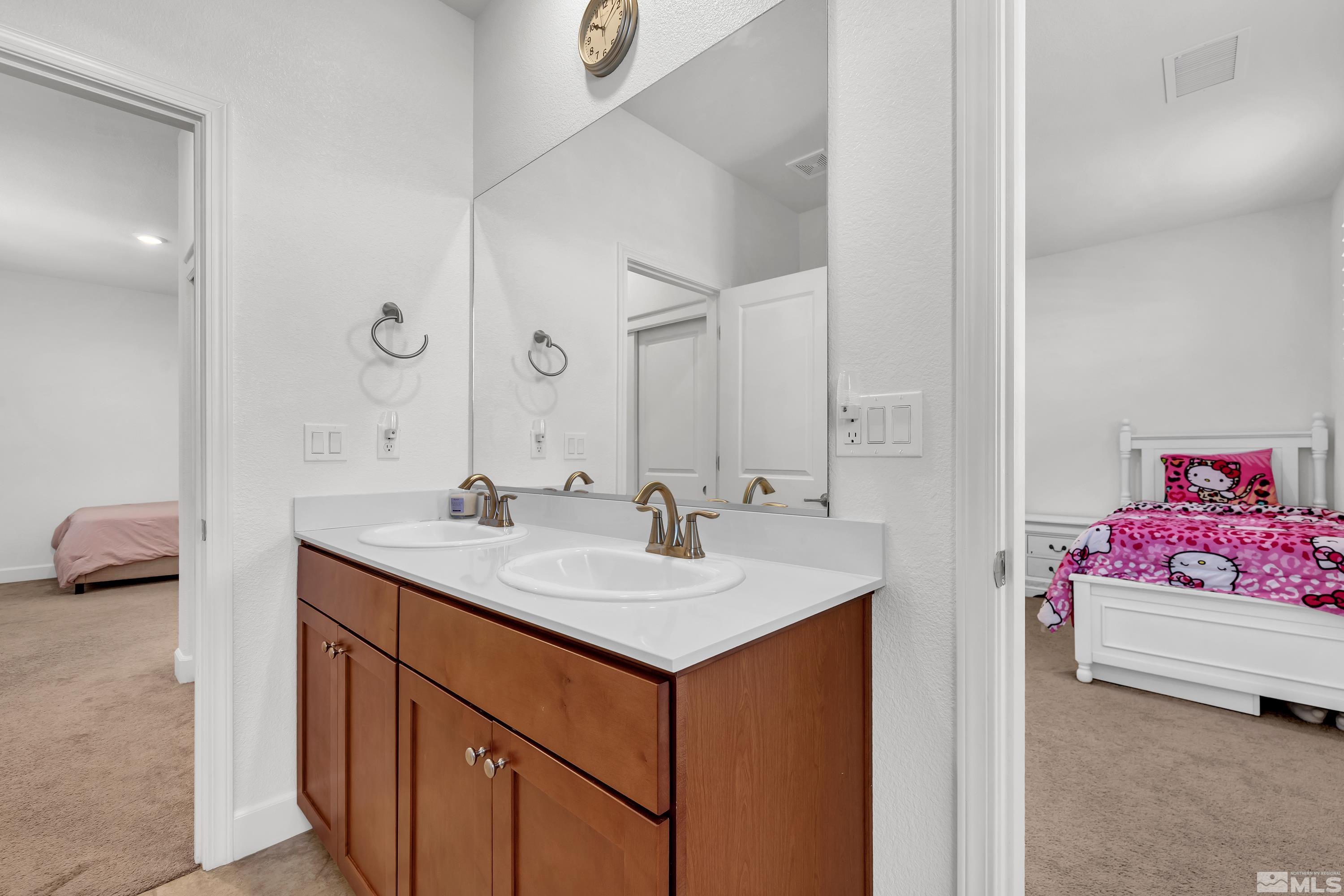 10310 Alchemy Way Reno, NV 89521 - Photo 19 of 30 a en suite bathroom with a sink and a mirror