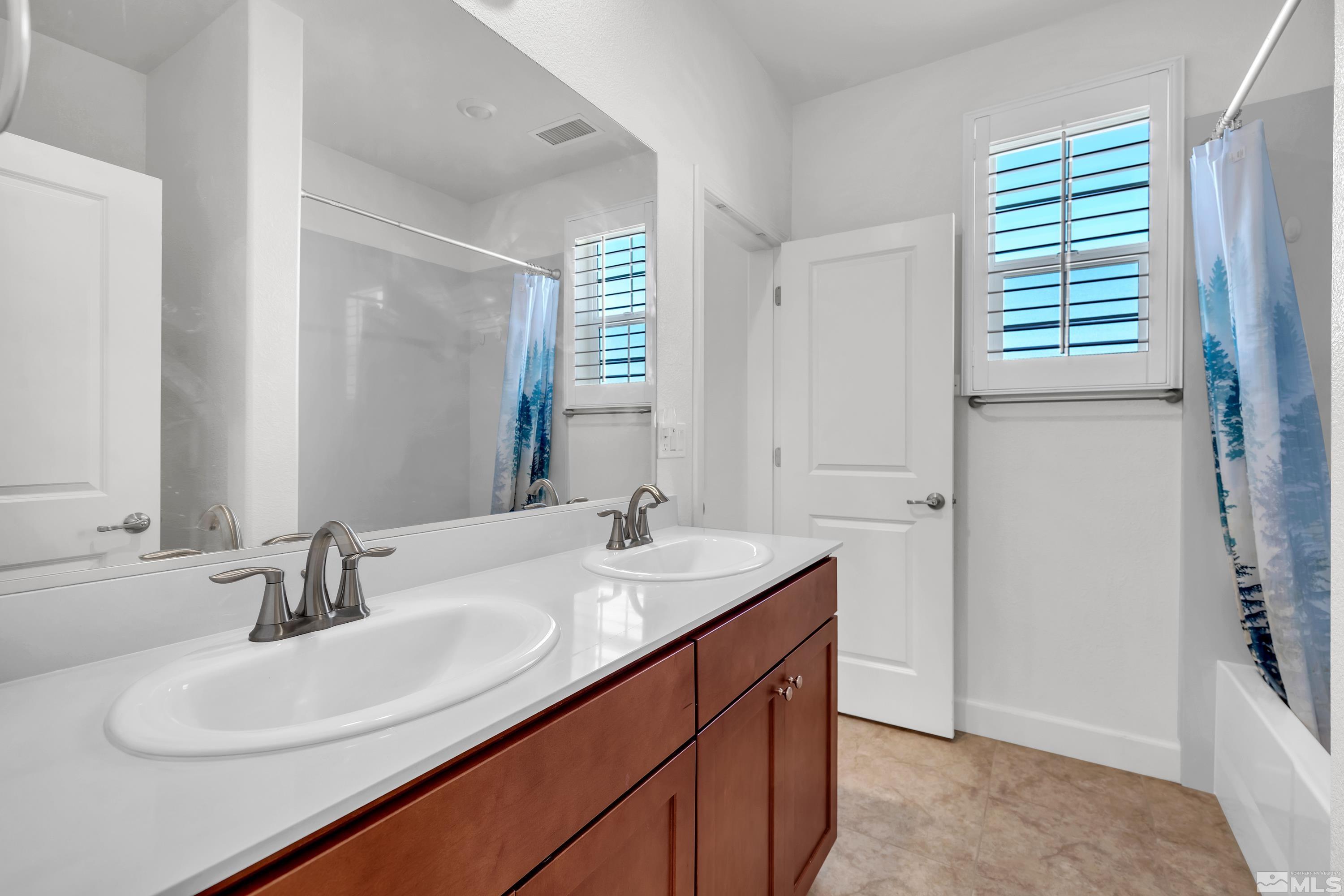 10310 Alchemy Way Reno, NV 89521 - Photo 20 of 30 a bathroom with a sink double vanity and a mirror