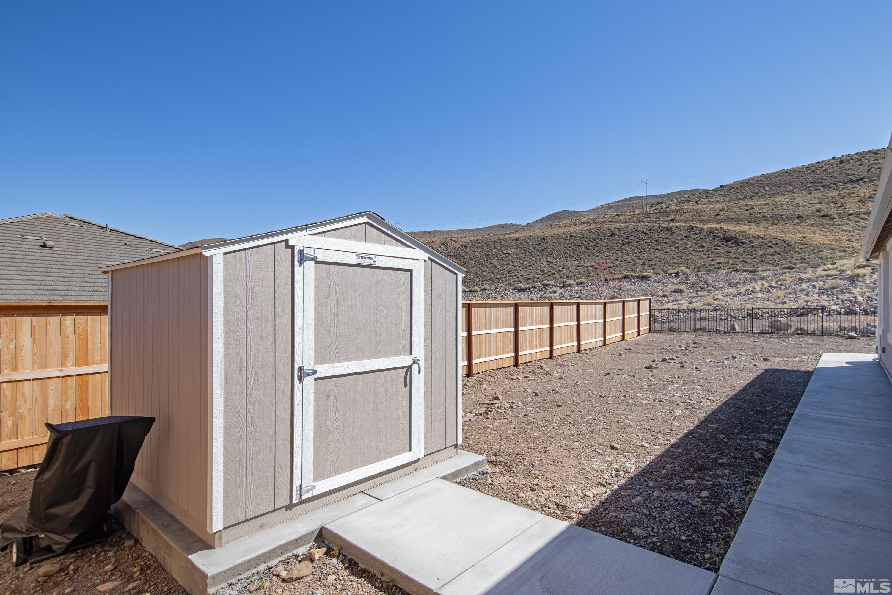 10310 Alchemy Way Reno, NV 89521 - Photo 23 of 30 a view of backyard with seating space and hardwood floor