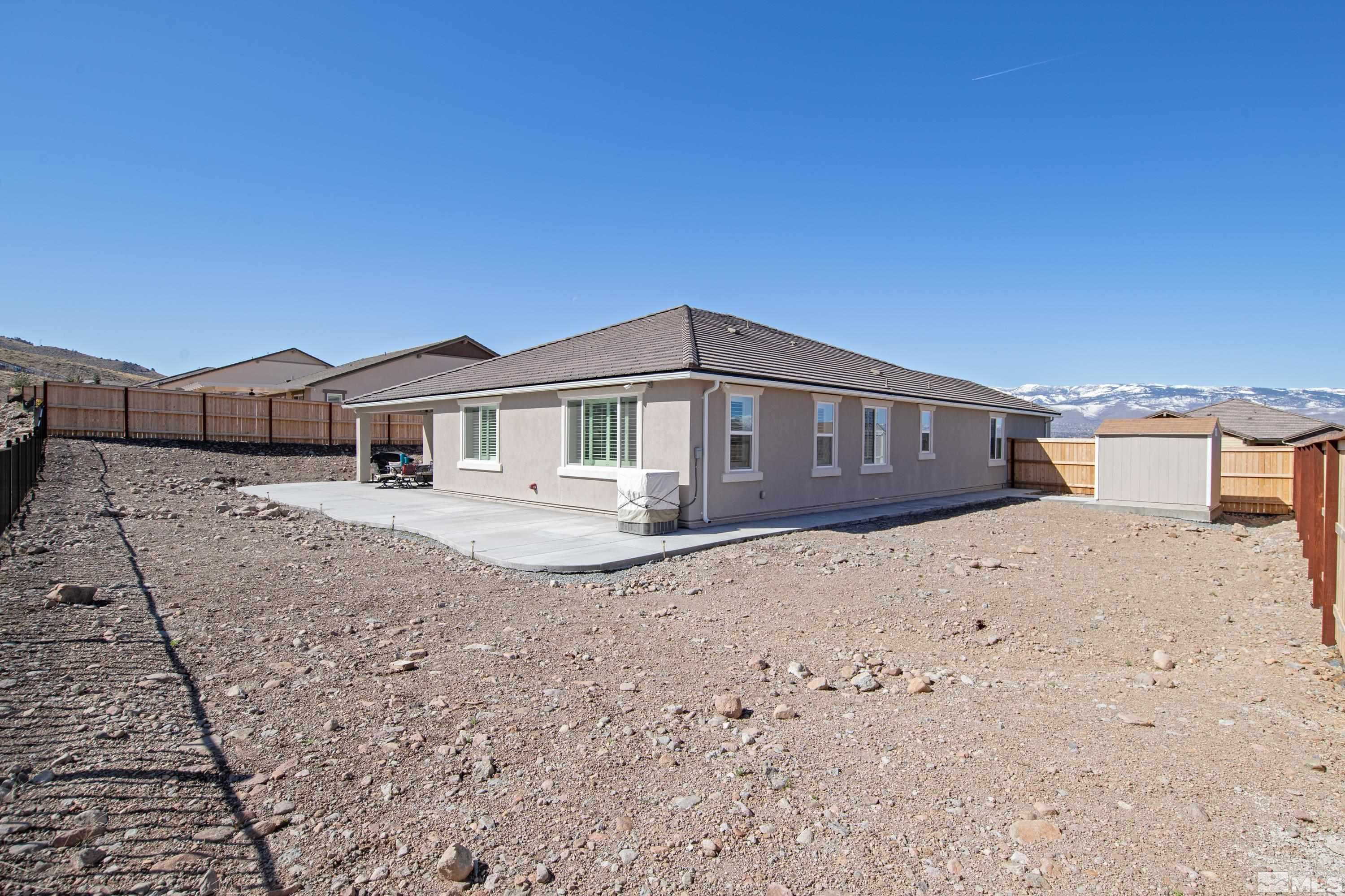 10310 Alchemy Way Reno, NV 89521 - Photo 26 of 30 a front view of a house with a yard