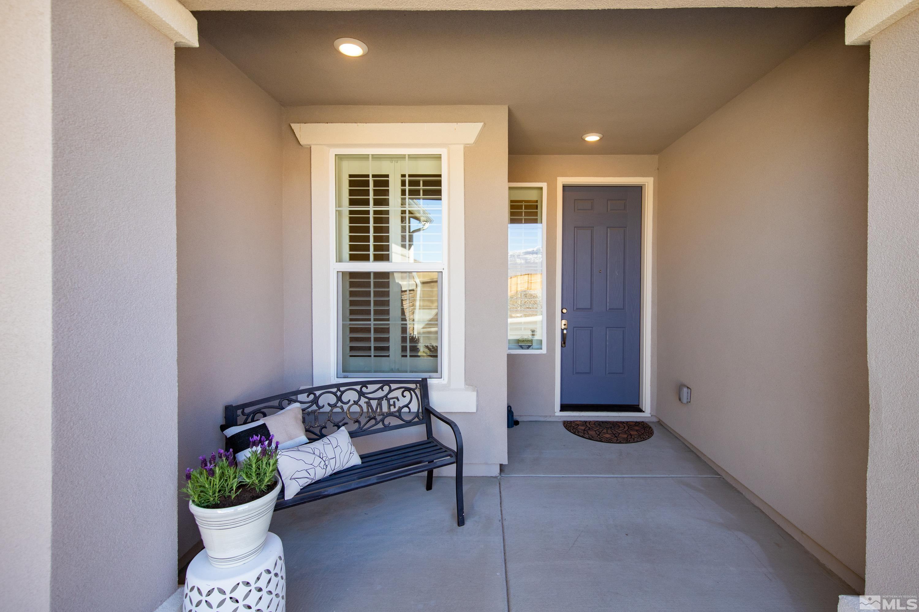 10310 Alchemy Way Reno, NV 89521 - Photo 3 of 30 a building outdoor space with patio furniture and potted plants