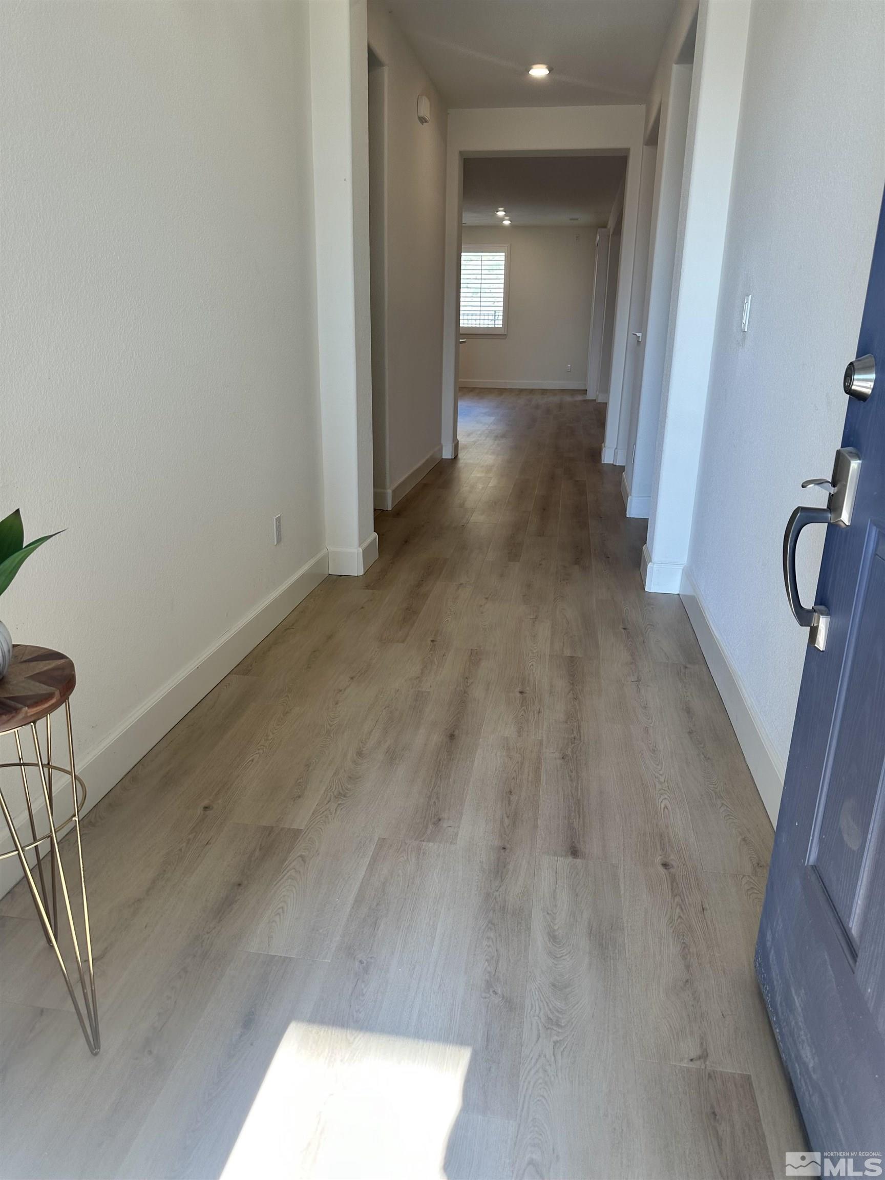 10310 Alchemy Way Reno, NV 89521 - Photo 4 of 30 a view of a hallway with wooden floor