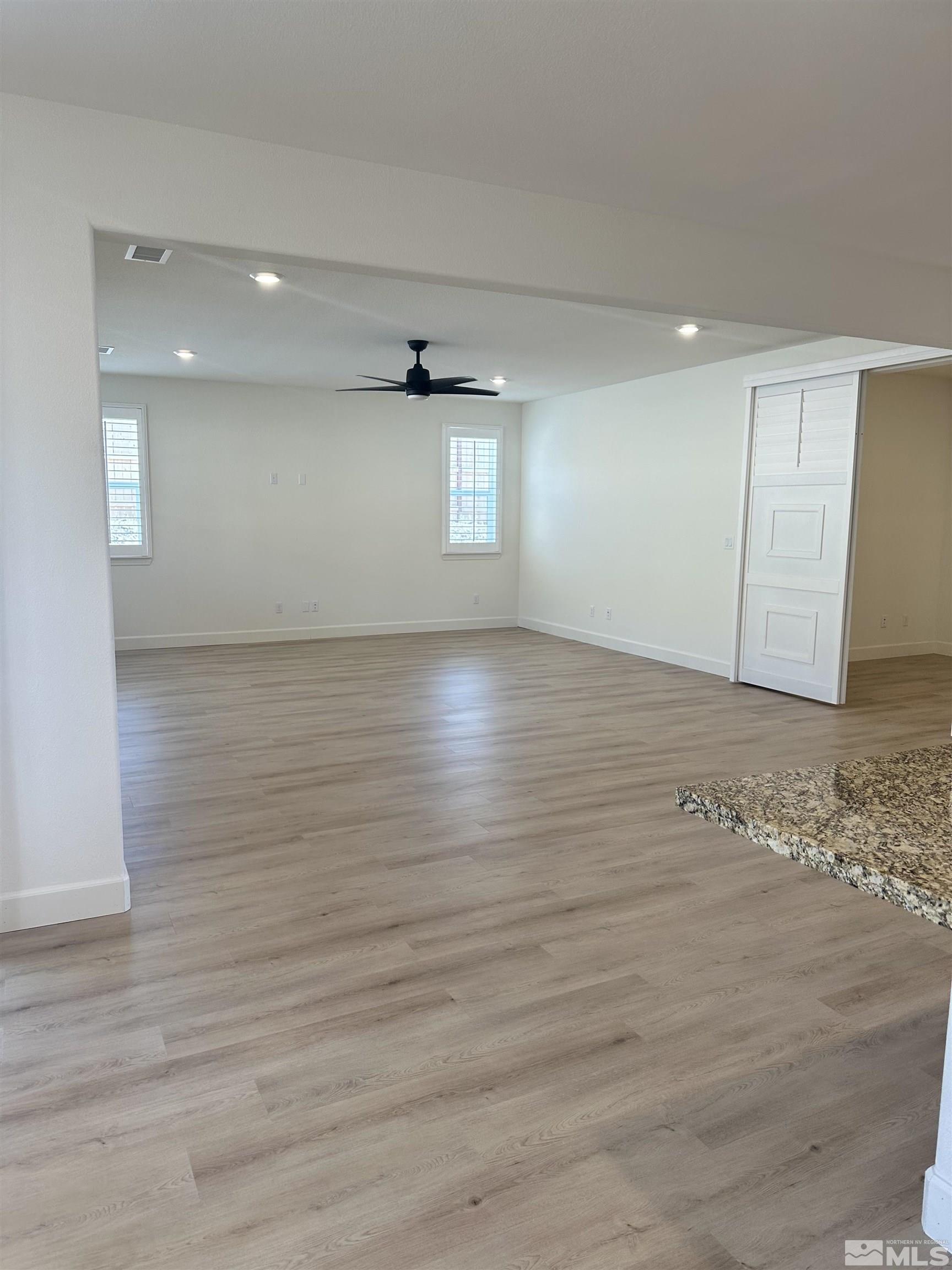 10310 Alchemy Way Reno, NV 89521 - Photo 7 of 30 a view of empty room with wooden floor