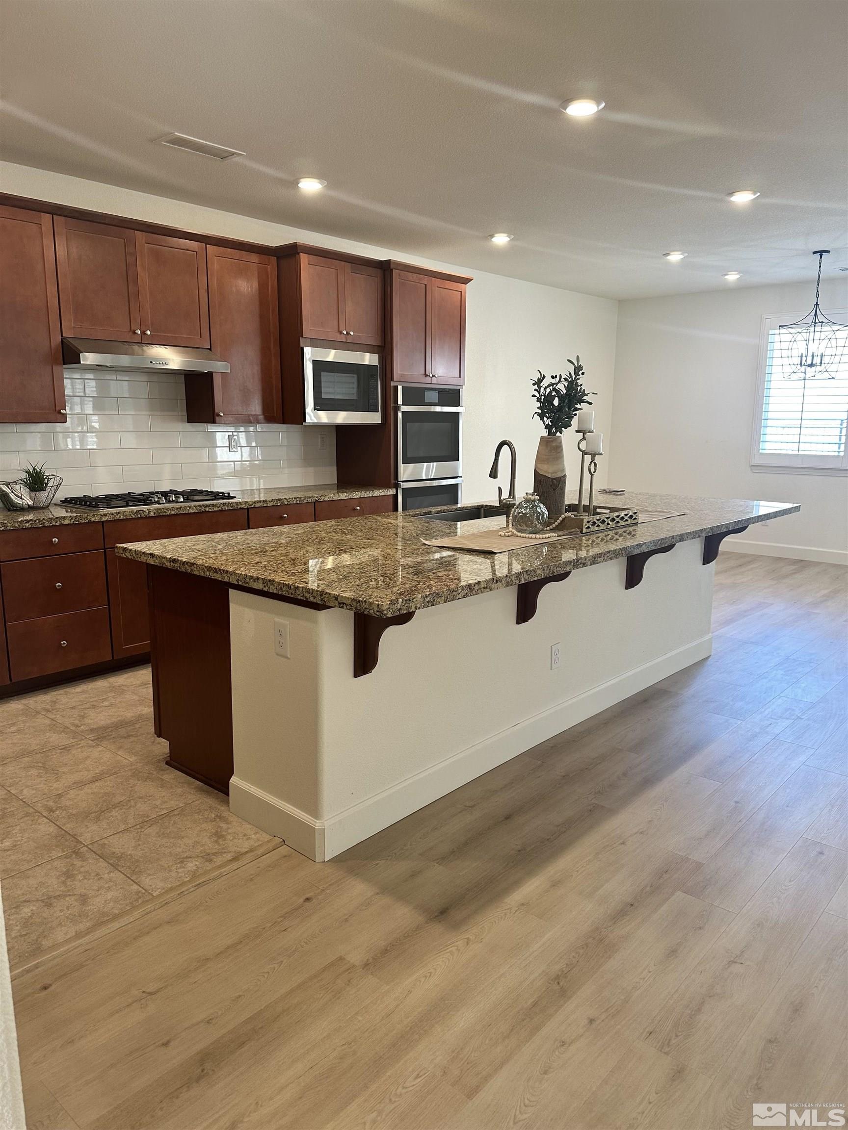 10310 Alchemy Way Reno, NV 89521 - Photo 10 of 30 a view of kitchen with stainless steel appliances granite countertop a stove and a sink