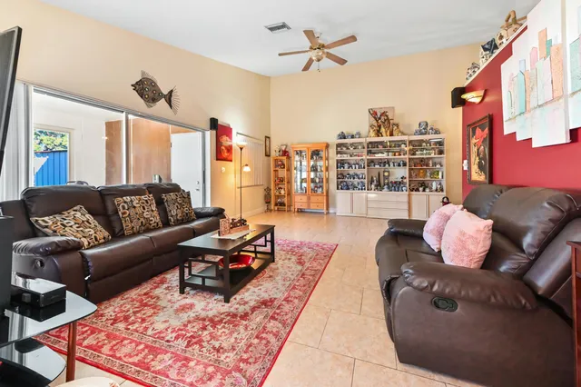 a living room with furniture a rug and a chandelier