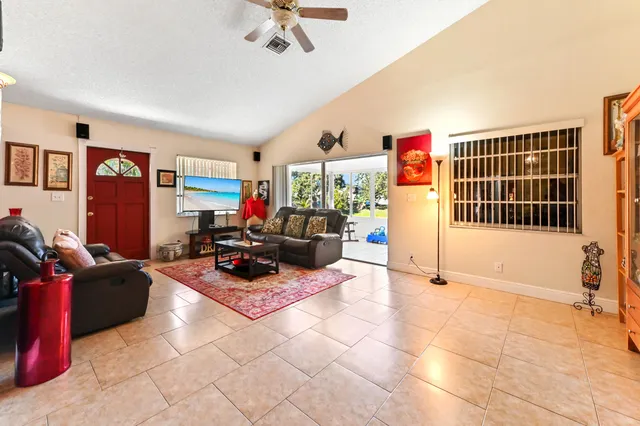 a living room with furniture cabinets and a flat screen tv