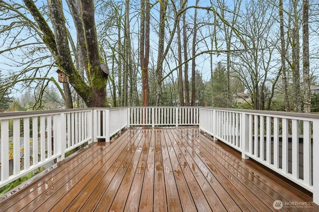 a view of balcony with wooden floor and fence