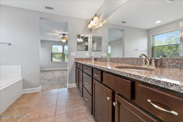 a bathroom with a sink double vanity and a mirror