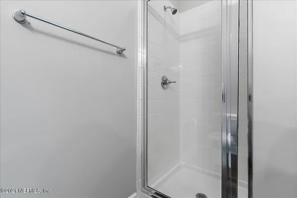 a bathroom with a glass shower door