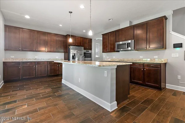a kitchen with stainless steel appliances granite countertop a sink counter space cabinets and a counter top space