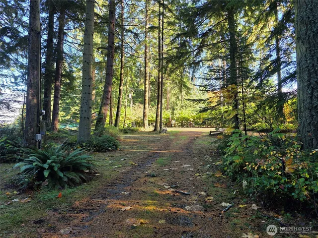 a backyard of a house with a yard and outdoor seating
