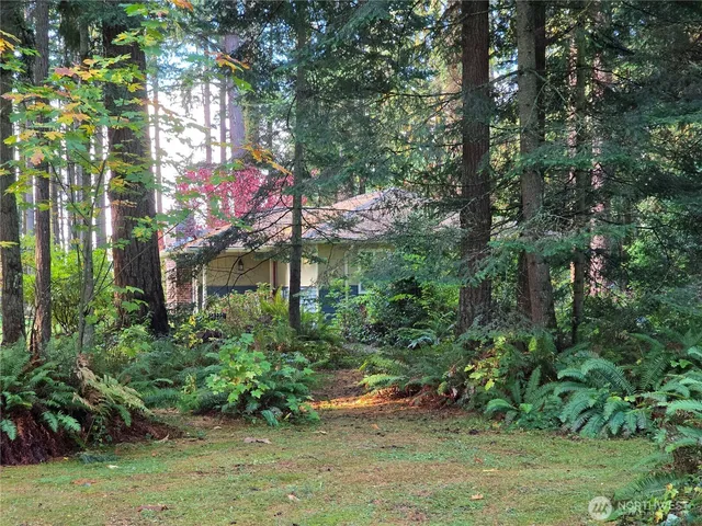 a balcony with wooden floor table and chairs