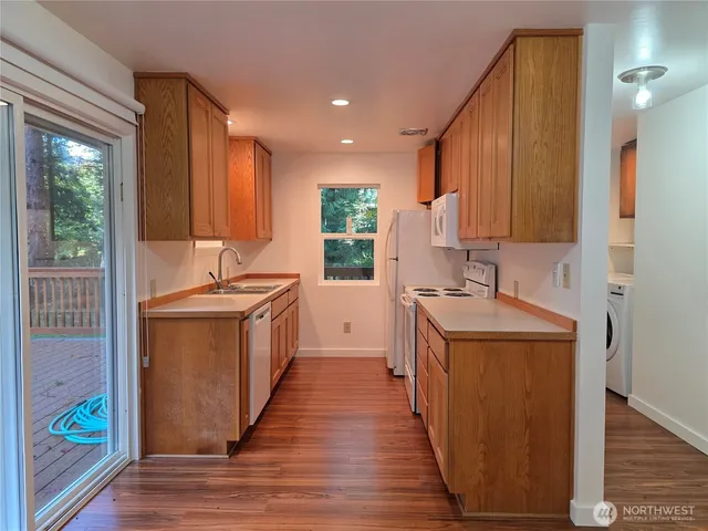 a kitchen with a sink stove and wooden cabinets