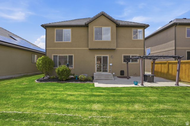 2007 Fielding Hill Lane Draper, UT 84020 - Photo 45 of 83 Expansive green lawn with a concrete patio featuring a pergola
