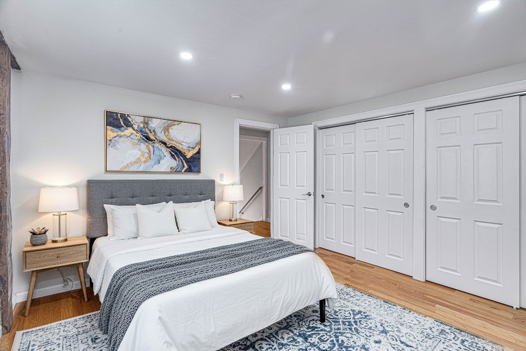 32 Northey Street, Unit 32 Salem, MA 01970 - Photo 11 of 29 a bedroom with a large bed and a painting on the wall