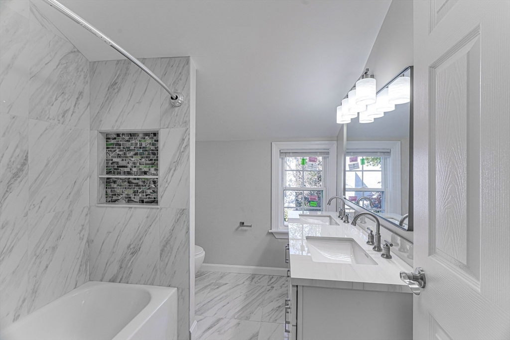 32 Northey Street, Unit 32 Salem, MA 01970 - Photo 15 of 29 a bathroom with a sink tub shower and a mirror