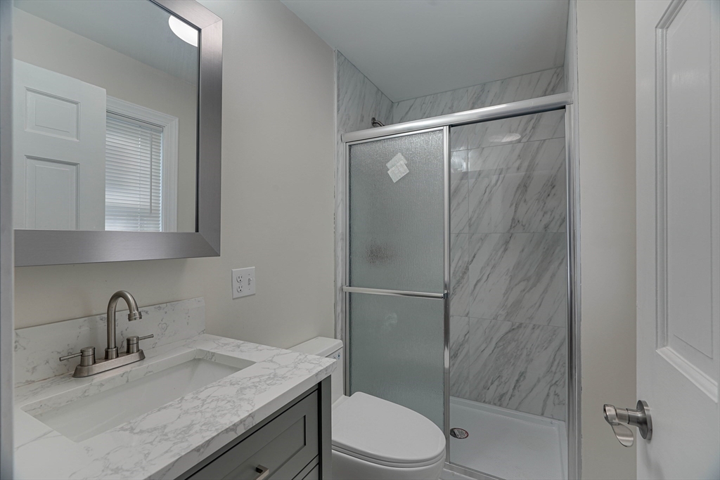 32 Northey Street, Unit 32 Salem, MA 01970 - Photo 21 of 29 a bathroom with a granite countertop sink toilet and shower