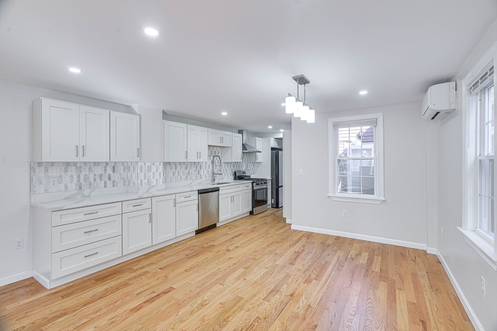 32 Northey Street, Unit 32 Salem, MA 01970 - Photo 4 of 29 a large kitchen with kitchen island a sink stainless steel appliances and cabinets