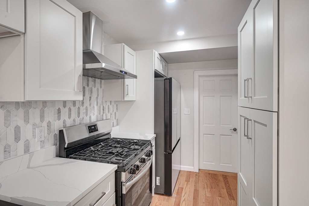 32 Northey Street, Unit 32 Salem, MA 01970 - Photo 5 of 29 a kitchen with stainless steel appliances a stove a refrigerator and cabinets