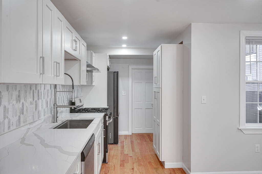 32 Northey Street, Unit 32 Salem, MA 01970 - Photo 8 of 29 a kitchen with a sink a stove and refrigerator