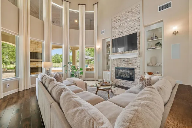 a living room with furniture windows and a fireplace